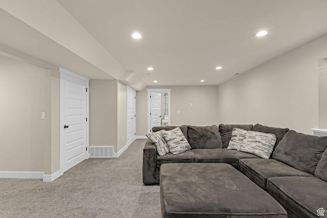 living area featuring recessed lighting, baseboards, visible vents, and light colored carpet