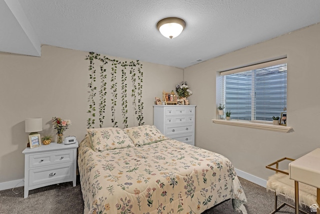 bedroom with dark carpet, baseboards, a textured ceiling, and visible vents