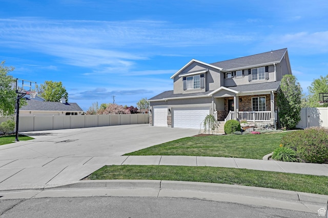 traditional home featuring a front lawn, driveway, stone siding, covered porch, and fence
