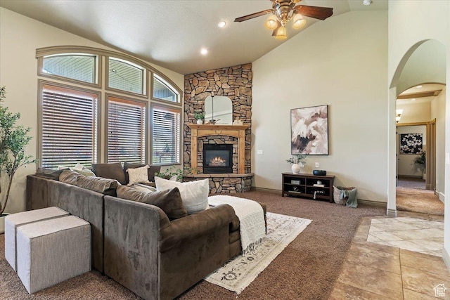 5328 N 3275 E, Liberty, UT 84310 - carpeted living room with arched walkways, a ceiling fan, a stone fireplace, and plenty of natural light