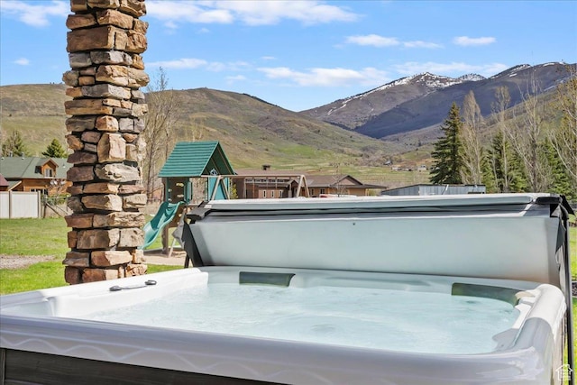 5328 N 3275 E, Liberty, UT 84310 - view of patio featuring fence, a hot tub, a mountain view, and a playground
