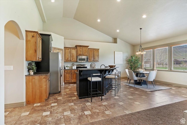 5328 N 3275 E, Liberty, UT 84310 - kitchen featuring a kitchen island with sink, a kitchen bar, brown cabinetry, appliances with stainless steel finishes, and high vaulted ceiling