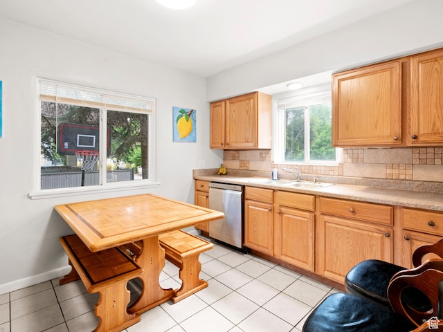kitchen featuring light countertops, tasteful backsplash, dishwasher, and a sink