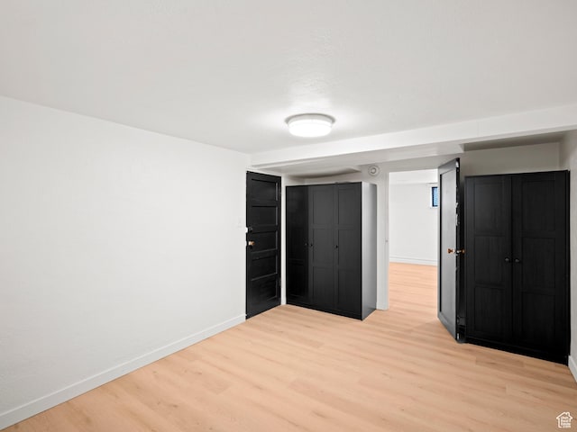 unfurnished bedroom with light wood-style floors and baseboards