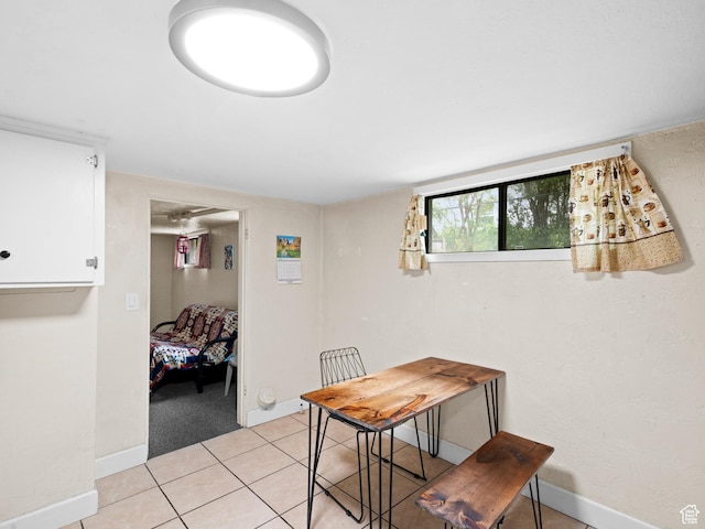 dining area featuring baseboards and light tile patterned floors