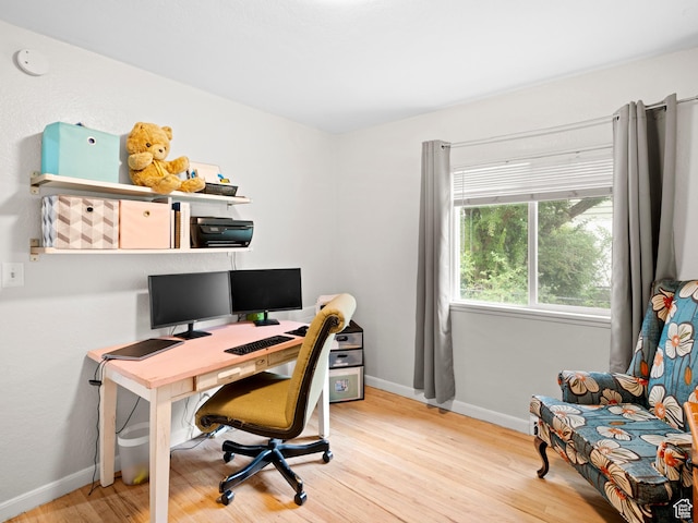 home office featuring baseboards and wood finished floors