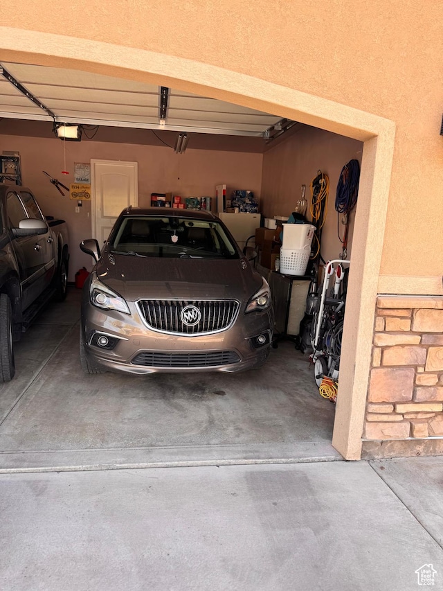 532 N 300 E, Roosevelt, UT 84066 - garage featuring driveway and a garage door opener