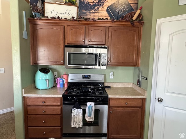 532 N 300 E, Roosevelt, UT 84066 - kitchen with light countertops, appliances with stainless steel finishes, baseboards, and brown cabinets