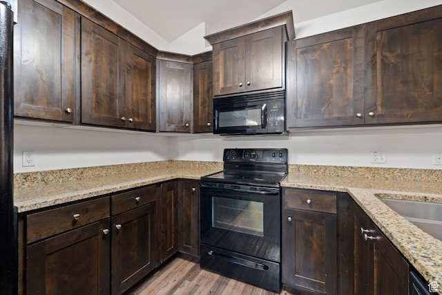 1045 S 1700 W Unit 1032, Payson, UT 84651 - kitchen with dark brown cabinets, light stone countertops, light wood-style floors, and black appliances