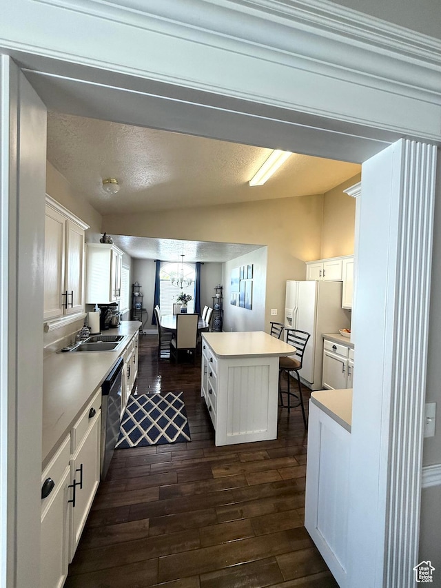 909 E 1520 N, American Fork, UT 84003 - kitchen with white refrigerator with ice dispenser, dark wood finished floors, dishwashing machine, a center island, and white cabinetry