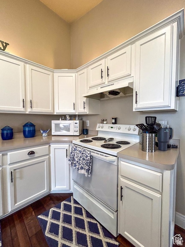 kitchen featuring white cabinetry, under cabinet range hood, and white appliances