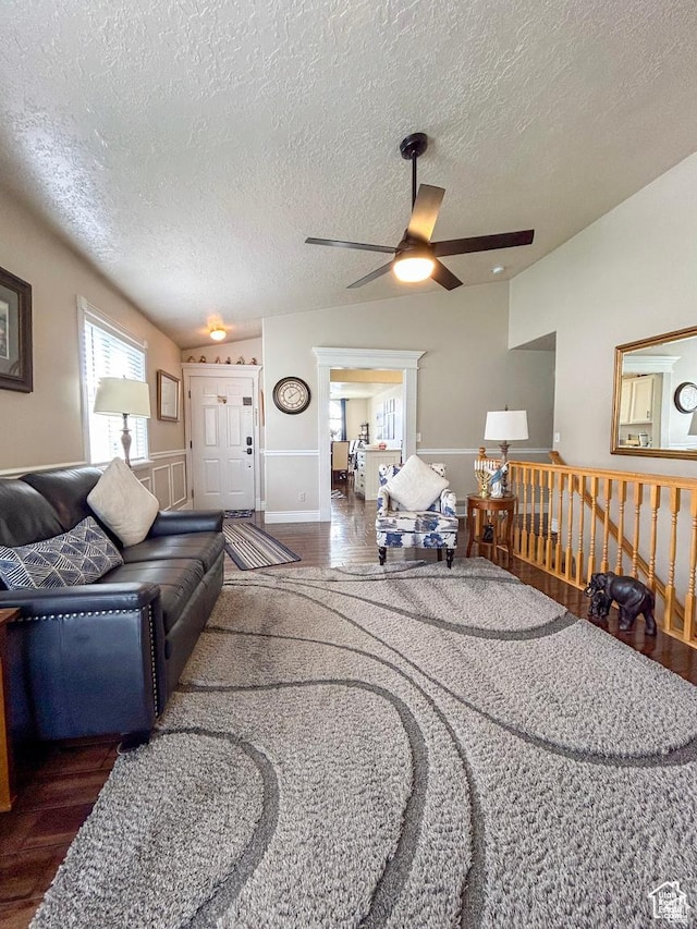 living area featuring a ceiling fan, wood finished floors, and a textured ceiling