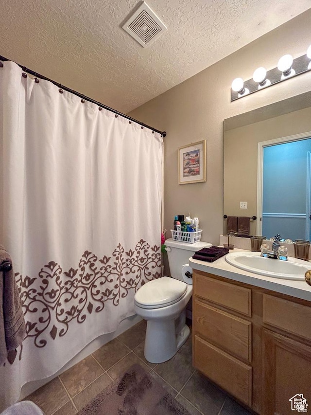 full bath with tile patterned flooring, visible vents, toilet, vanity, and a textured ceiling