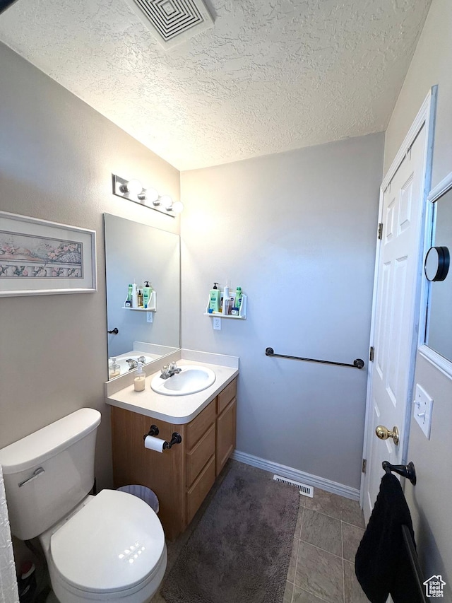 909 E 1520 N, American Fork, UT 84003 - bathroom with vanity, a textured ceiling, toilet, and tile patterned floors
