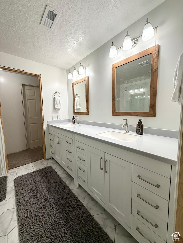 909 E 1520 N, American Fork, UT 84003 - bathroom with double vanity, marble finish floors, an enclosed shower, and a textured ceiling