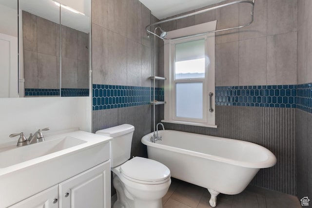751 E Browning Ave S, Salt Lake City, UT 84105 - full bathroom with tile patterned floors, toilet, tile walls, a freestanding tub, and vanity