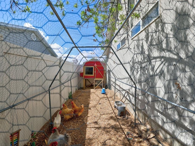 view of yard with an outdoor structure, fence, and exterior structure