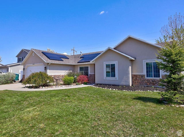 ranch-style house with a garage, solar panels, a front yard, and stucco siding