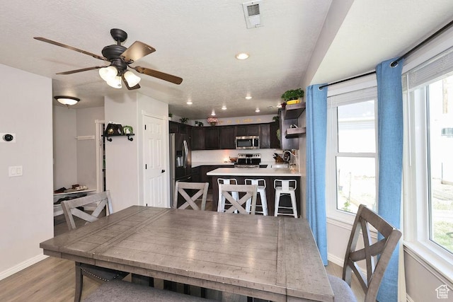 dining space with recessed lighting, visible vents, a ceiling fan, light wood-style floors, and baseboards