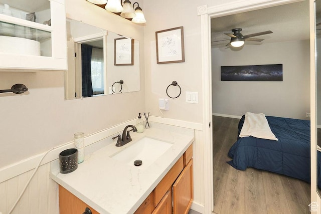 bathroom featuring wood finished floors, vanity, and ceiling fan