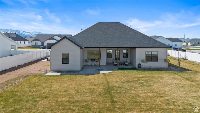 733 E 750 S, Preston, ID 83263 - rear view of property with a fenced backyard, a patio, a shingled roof, and a lawn