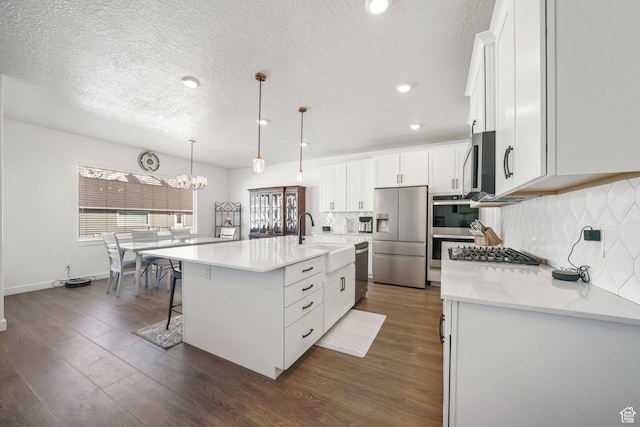788 N 2100 E, Spanish Fork, UT 84660 - kitchen featuring an inviting chandelier, a sink, decorative backsplash, and stainless steel appliances