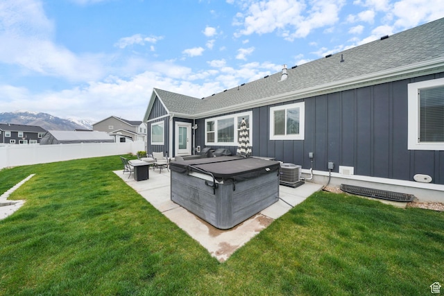 788 N 2100 E, Spanish Fork, UT 84660 - back of property with board and batten siding, a hot tub, a shingled roof, and a patio area