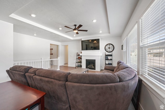 788 N 2100 E, Spanish Fork, UT 84660 - living area featuring ceiling fan, a textured ceiling, a fireplace, a tray ceiling, and recessed lighting