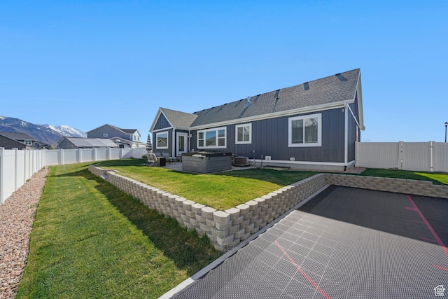 788 N 2100 E, Spanish Fork, UT 84660 - back of house featuring a fenced backyard, board and batten siding, a patio area, a lawn, and a hot tub