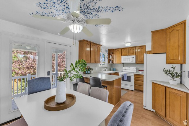 3788 W Hillsboro Cir, West Jordan, UT 84084 - kitchen featuring white appliances, ceiling fan, light wood finished floors, light countertops, and a peninsula
