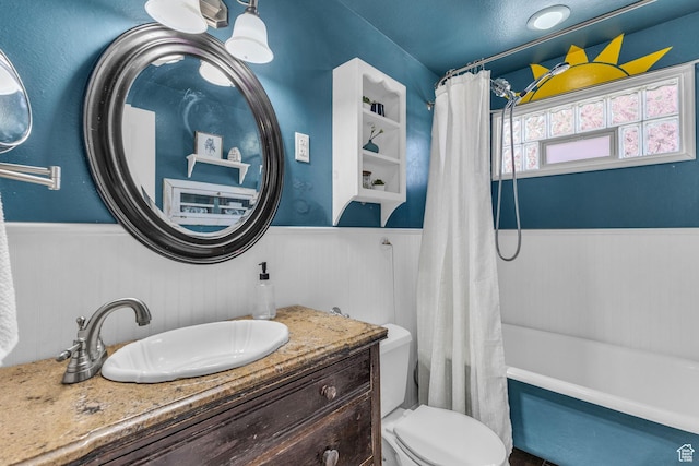3788 W Hillsboro Cir, West Jordan, UT 84084 - bathroom featuring shower / tub combo with curtain, a wainscoted wall, vanity, and toilet