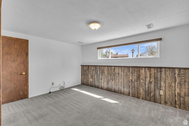 3788 W Hillsboro Cir, West Jordan, UT 84084 - carpeted empty room featuring wood walls and visible vents