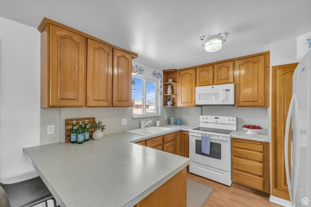 3788 W Hillsboro Cir, West Jordan, UT 84084 - kitchen featuring a sink, brown cabinets, white appliances, light countertops, and a peninsula