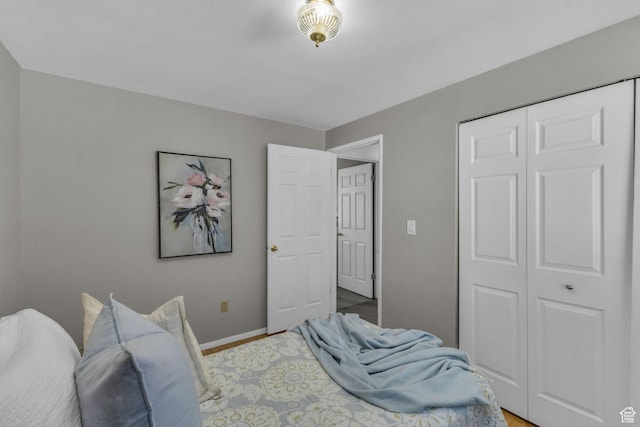 3788 W Hillsboro Cir, West Jordan, UT 84084 - bedroom with light wood-style flooring, baseboards, and a closet