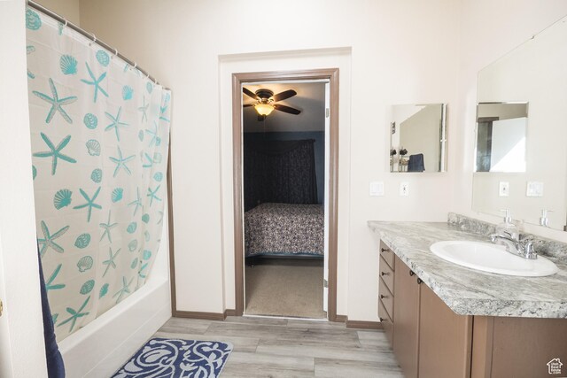 2036 W 1500 N, Vernal, UT 84078 - bathroom with shower / bathtub combination with curtain, wood finished floors, a ceiling fan, vanity, and baseboards