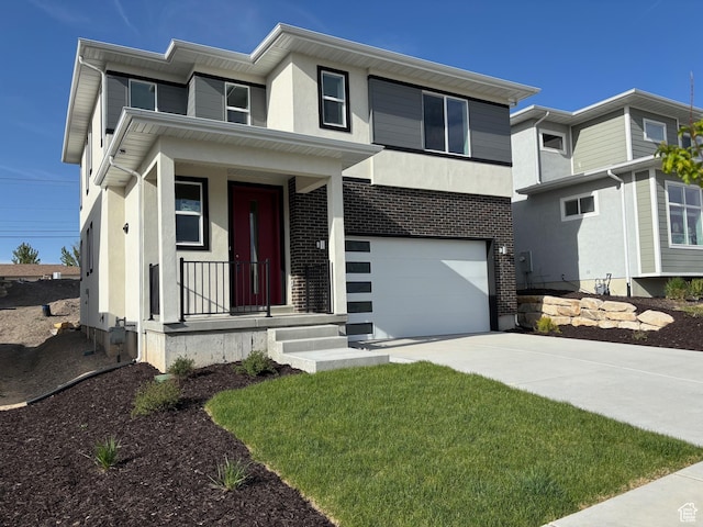 912 W Bellshill Dr Unit 15, Murray, UT 84123 - view of front of home featuring concrete driveway, a garage, stucco siding, and a porch