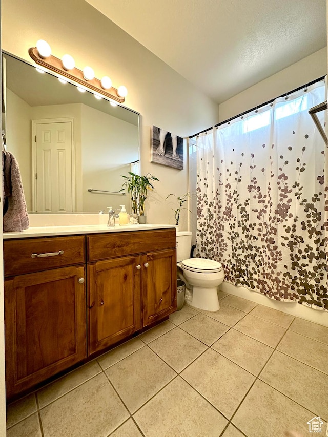 bathroom with vanity, toilet, tile patterned flooring, and curtained shower