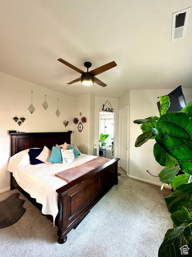 bedroom with visible vents, carpet flooring, baseboards, and ceiling fan