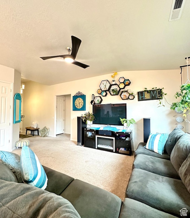 living room featuring baseboards, a ceiling fan, visible vents, and carpet flooring