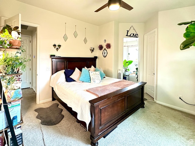 bedroom with baseboards, a ceiling fan, and light colored carpet