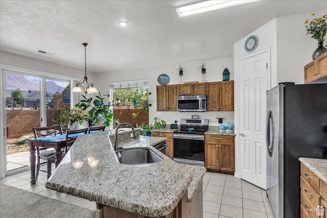 240 W 225 S, Ivins, UT 84738 - kitchen featuring stainless steel appliances, brown cabinetry, a textured ceiling, and recessed lighting