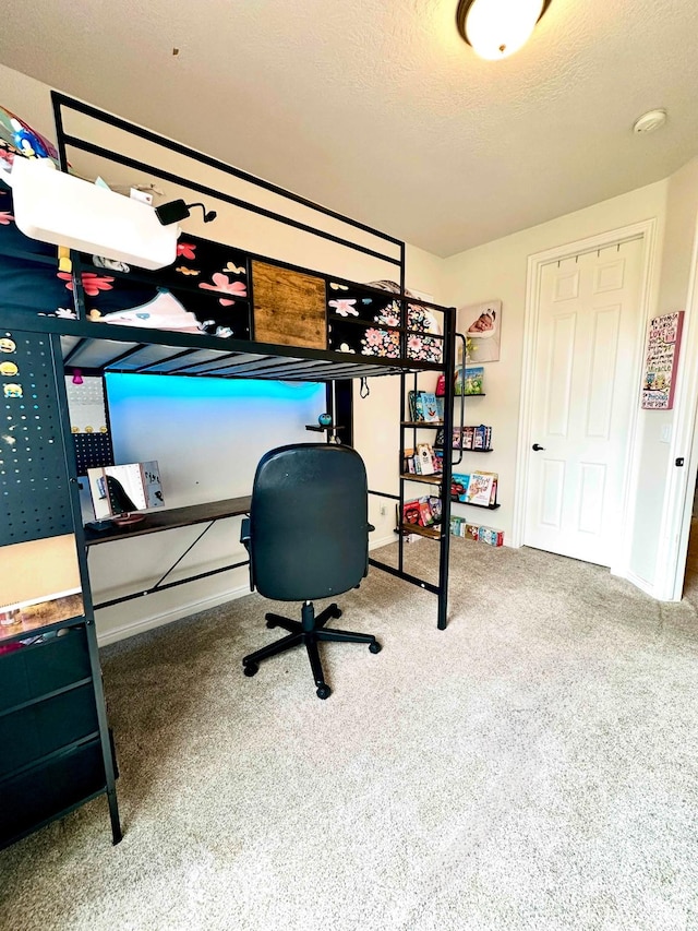 bedroom with carpet floors and a textured ceiling
