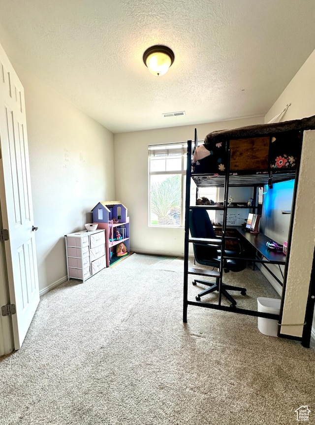 carpeted bedroom with a textured ceiling and visible vents