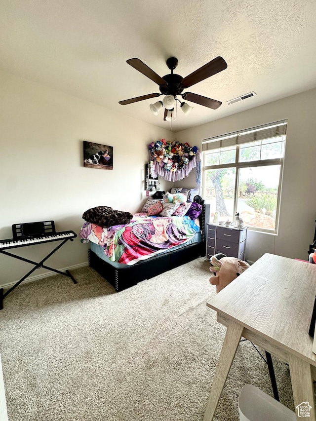 carpeted bedroom featuring baseboards, visible vents, and ceiling fan