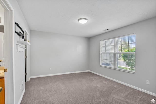 3560 S Vista Villa Ln Unit A, West Valley City, UT 84120 - carpeted spare room with a textured ceiling, visible vents, and baseboards