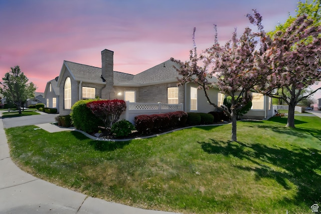 3560 S Vista Villa Ln Unit A, West Valley City, UT 84120 - property exterior at dusk featuring a lawn and a chimney
