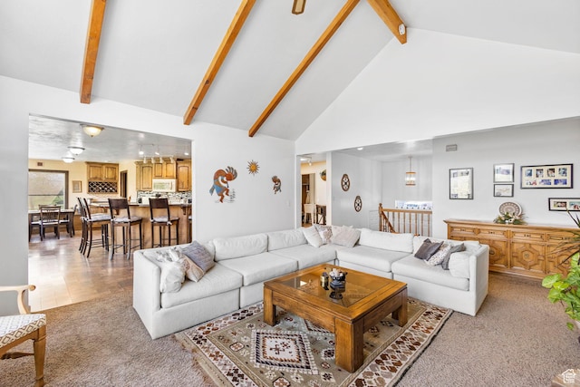 living room featuring beamed ceiling, high vaulted ceiling, and light colored carpet