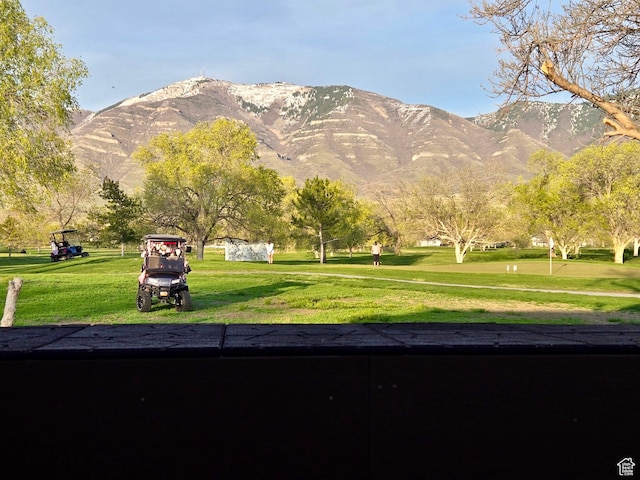 view of property's community with a lawn and a mountain view