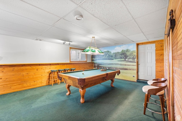 rec room featuring wooden walls, pool table, carpet flooring, and a paneled ceiling