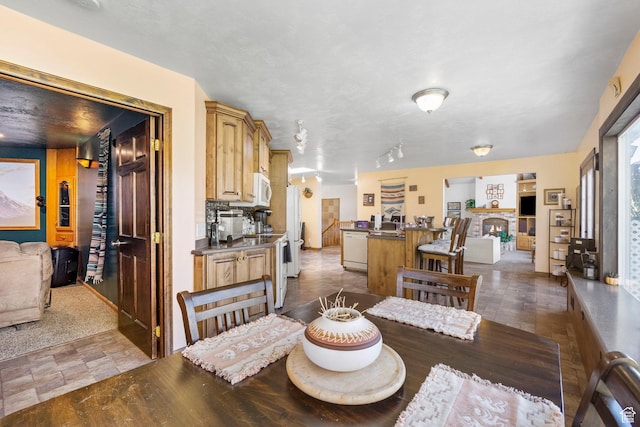 dining space featuring a lit fireplace